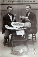 Black and white photograph of W. L. Carlyle and R. S. Mackintosh eating watermelon that was awarded first premium probably at the Minnesota State Fair, 1895.