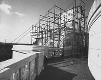 Black and white photograph of the Quadriga encased in scaffolding during application of gold leaf, 1979. Photographed by Elizabeth M. Hall.