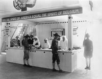 Black and white photograph of a Red Cross booth (Let the Spirit of America Equal the Spirit of Belgium) at the 1917 Minnesota State Fair.