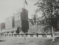 Black and white photograph showing the tents of D Company, First Minnesota Infantry, on guard duty at the Pillsbury mills, 1917.