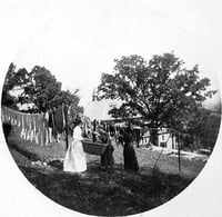 Black and white photograph entitled Hanging up the clothes at the James J. Hill House, 240 Summit, St. Paul, c.1900.