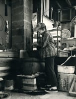 Gene Ritchie Monahan working at her kiln