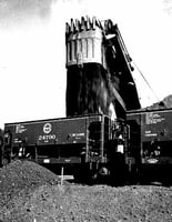 Black and white photograph of ore cars being loaded at the Hull-Rust mine at Hibbing, 1937.