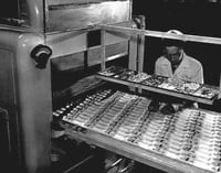 Pearson Candy Company employee checking chocolates on conveyor belt, St. Paul, ca. 1970.