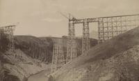 Black and white photograph of the Great Northern Railway trestle over Two Medicine in course of construction, ca. 1877.