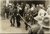 Black and white photograph of Vincent R. Dunne, strike committee member, arrested and held at the provost guard stockade at the State Fair grounds, 1934.