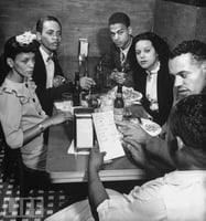 Black and white photograph of Hilda Simms with Earl Hollman and other actors from the Harlem Theater in New York City, c.1943.