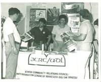 Black and white photograph of booth staffed by members of the JCRC/ADL at the Minnesota State Fair, c.1986.