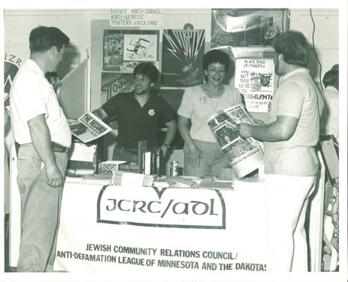 Black and white photograph of booth staffed by members of the JCRC/ADL at the Minnesota State Fair, c.1986.