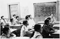 Black and white photograph of Hmong students in a class at the Lao Family Community Center inside a branch of the St. Paul YMCA, c.1980.