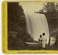 Black and white photograph of visitors below the falls, c.1869.