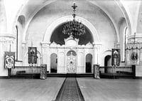Black and white photograph of the interior of the sanctuary in St. Mary’s Orthodox Cathedral, Minneapolis with an icon screen and banners, c.1906.