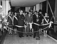Black and white photograph of he opening of the first Minneapolis skyway, connecting the Northstar Center and the Northwestern National Bank Leslie Park is at left, 1962.