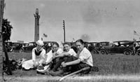 Group next to memorial tree planted on Victory Memorial Drive