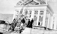 Black and white photograph of construction workers in front of the conservatory, ca. 1915.