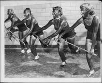 University of Minnesota students, and members of the campus Aquatic League, practice a dance number in blackface for the comic water ballet to be performed in the Cooke Hall exhibition pool on Friday night. L to R: Susan Fredrickson of Santa Cruz, California Trudy Schlek of Milwaukee, Wisconsin Kit Thiele of Madison, Minnesota and Gerrie Ghent of St. Paul, rehearse a Licorice Lindy dance number with canes in Cooke Hall. Originally published in the Minneapolis Tribune, April 14, 1950.