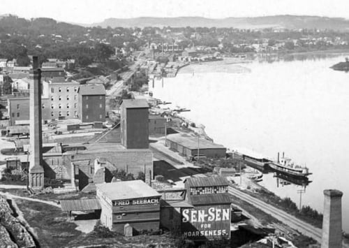 Black and white photograph of Red Wing riverfront including remnants of Red Wing Mills, c.1885.