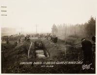 Black and white photograph of mass grave at Moose Lake after the fire, 1918.