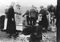 Black and white photograph of Red Cross workers serving meals to National Guard and survivors, Moose Lake forest fire, 1918.