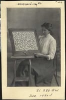 photograph of a young woman displaying bobbin lace