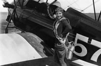Black and white photograph of Klingensmith with one of her aircraft, a Waco biplane, ca. 1930.