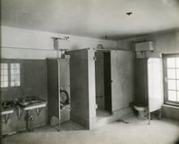 Black and white photograph of a the mail carrier’s (men’s) toilet inside the Anoka Post Office, January 11, 1917.