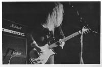 Black and white photograph of Kat Bjelland performing with Babes in Toyland in Paris, 1991.