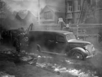 Photograph of Minneapolis firefighters trying to move a Hennepin County Morgue truck after being iced in during a January 3, 1940 fire at the Marlborough Apartment Hotel