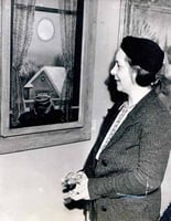 Black and white photograph of Elsa Laubach Jemne viewing Clement Haupers’ oil painting Early Moon in St. Paul, 1938.