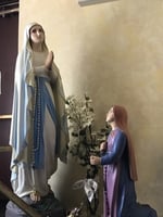 Color image of Sculptures of the Virgin Mary (at left) and Saint Bernadette (Bernadette Soubirous, at right). Interior of Our Lady of Lourdes Church, 27 Prince Street, Minneapolis, 2017. Photograph by Courtney Gregar.