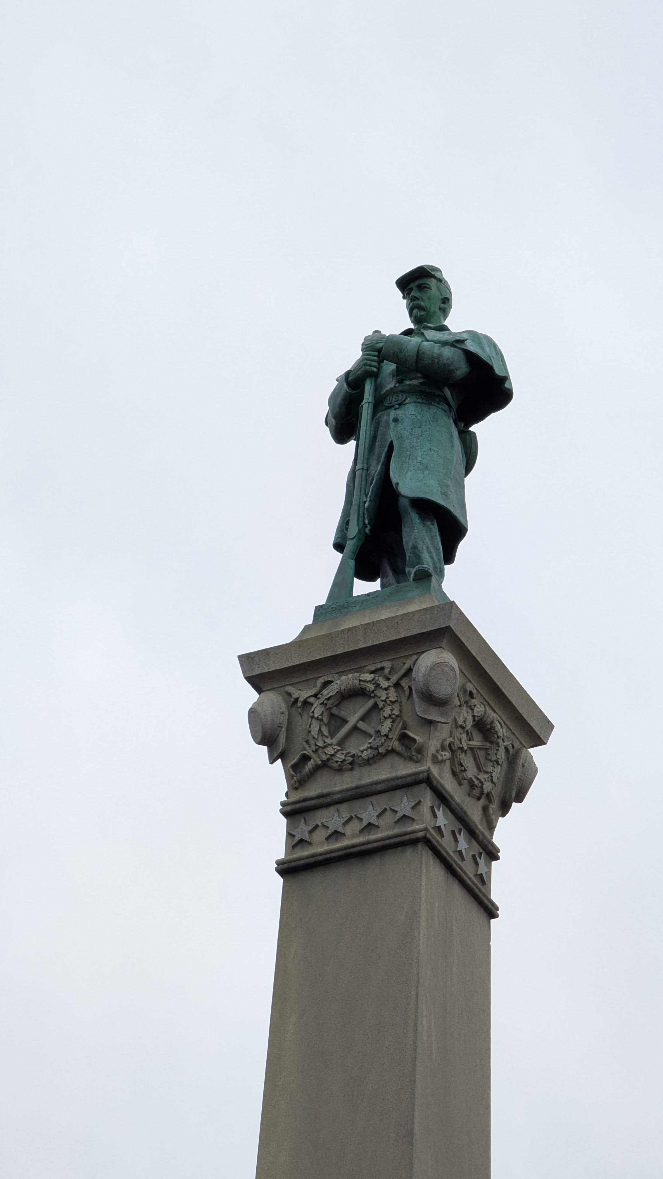 Upper half of the eastern side of the memorial, featuring the sculpture of Josias R. King.