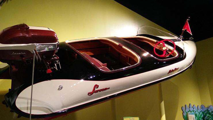 A 1956 model &quot;Falls Flyer.&quot; A molded fiberglass boat with a twin cockpit and round hull.