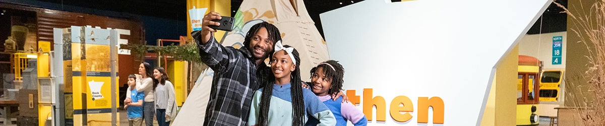 A group of people taking a photo in an exhibit.