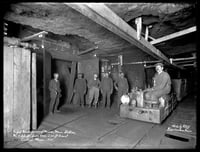 Black and white photograph of miners inside the Fayal mine in Eveleth, 1915. Photographed by William F. Roleff.