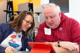 two teachers looking at device