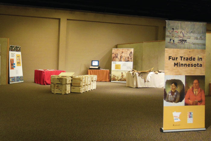 Fur Trade exhibit signage set around a stack of wooden crates.