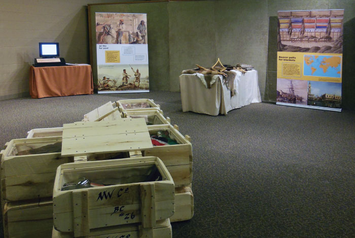 A stack of wooden crates sit in front of signage.
