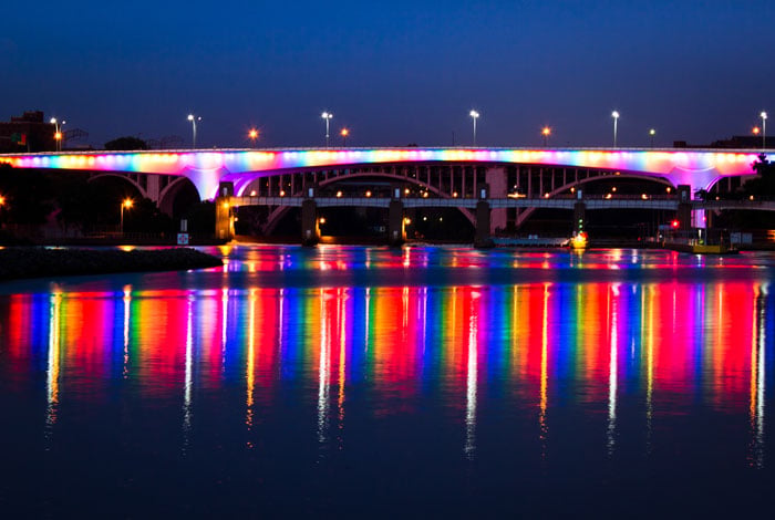 Minneapolis 35W bridge lit with many colors at night.