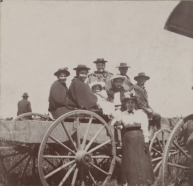 Black and white photograph of an eight-person mixed-race Ojibwe family, including a baby, on the White Earth Reservation, ca. 1897.
