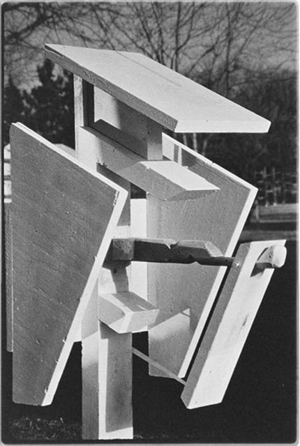Geometric wooden shapes poised to come together to form a nest box.