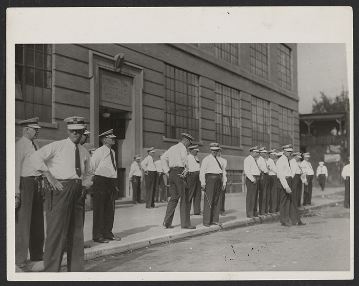 Police at the entrance to the Strutwear Knitting Company