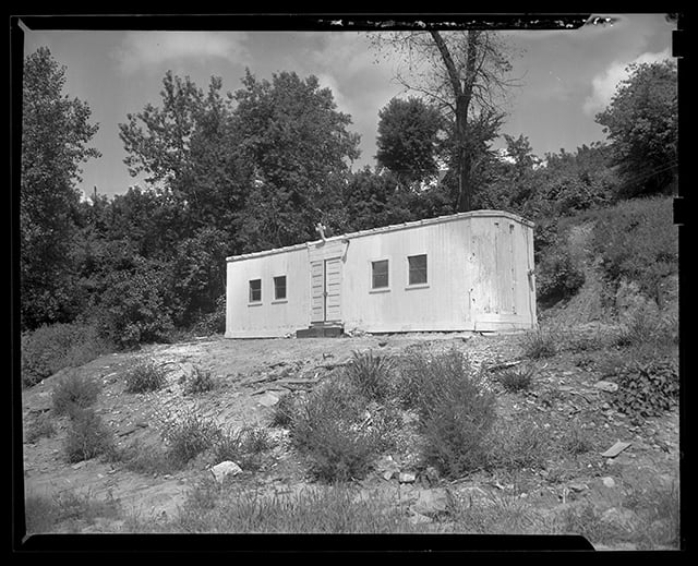 Black and white photograph of boxcar chapel in Swede Hollow, 1949.