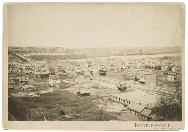 Black and white photograph of the lower West Side and Wabasha Bridge, c.1885.