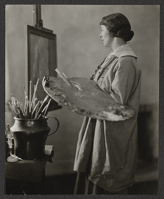 Black and white photograph of Elsa L. Jemne working at an easel, 1922.