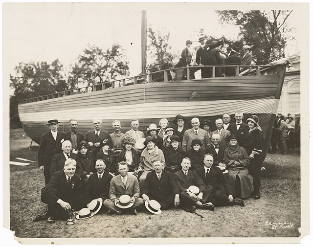 Norwegian Minnesotans posed for a picture with a sloop (boat).