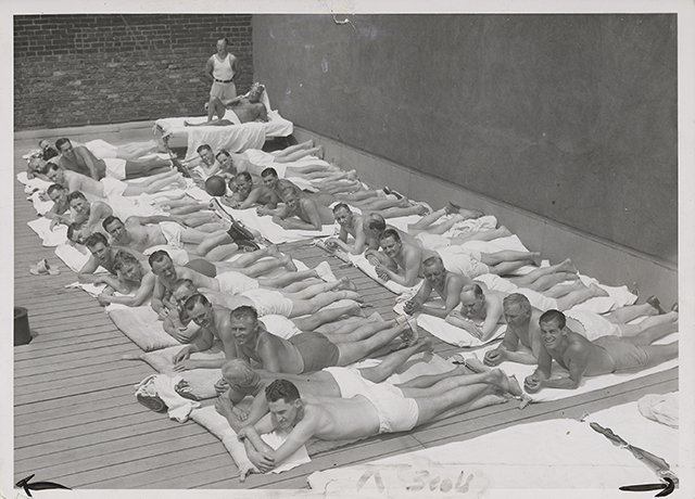 Black and white photograph of sun bathers on the sun deck of the St. Paul Athletic Club, c.1935.