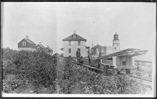 Black and white photograph of Split Rock Light Station and a tram car c.1916.