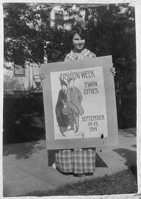 Photograph of Wanda Gág with a poster she submitted in a contest, 1914.