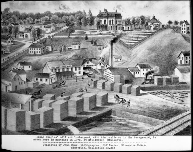 A black-and-white print showing a lumber mill in the foreground, with stacks of lumber, houses, horses, and workers, and a sawmill, and a mansion on top of a hill behind them.