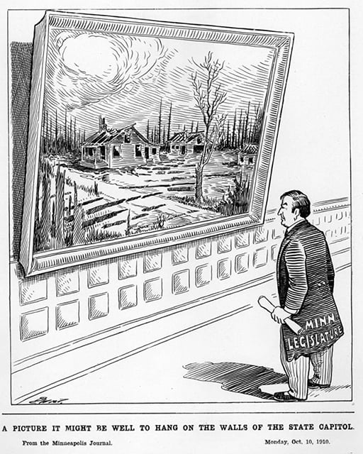 A figure with the words "Minn Legislature" on his coats, stands in front of a painting (hanging on a wall) of a burned group of buildings. Below him sits the caption, " the caption, “A Picture It Might Be Well to Hang on the Walls of the State Capitol.”